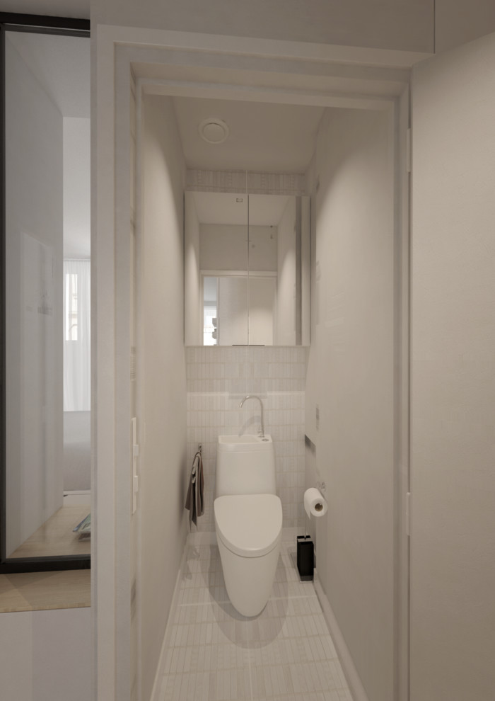 Réalisation d'un petit WC et toilettes design avec un placard à porte affleurante, des portes de placard blanches, WC à poser, un carrelage blanc, du carrelage en marbre, un mur blanc, un sol en marbre, une vasque et un sol blanc.