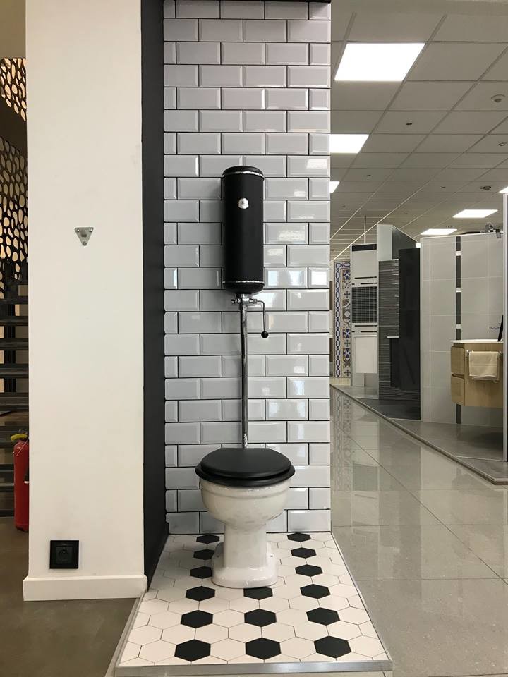 Small mid-century modern gray tile and terra-cotta tile cement tile floor and multicolored floor powder room photo in Montpellier with shaker cabinets, black cabinets, a bidet, gray walls, a trough sink, laminate countertops and black countertops