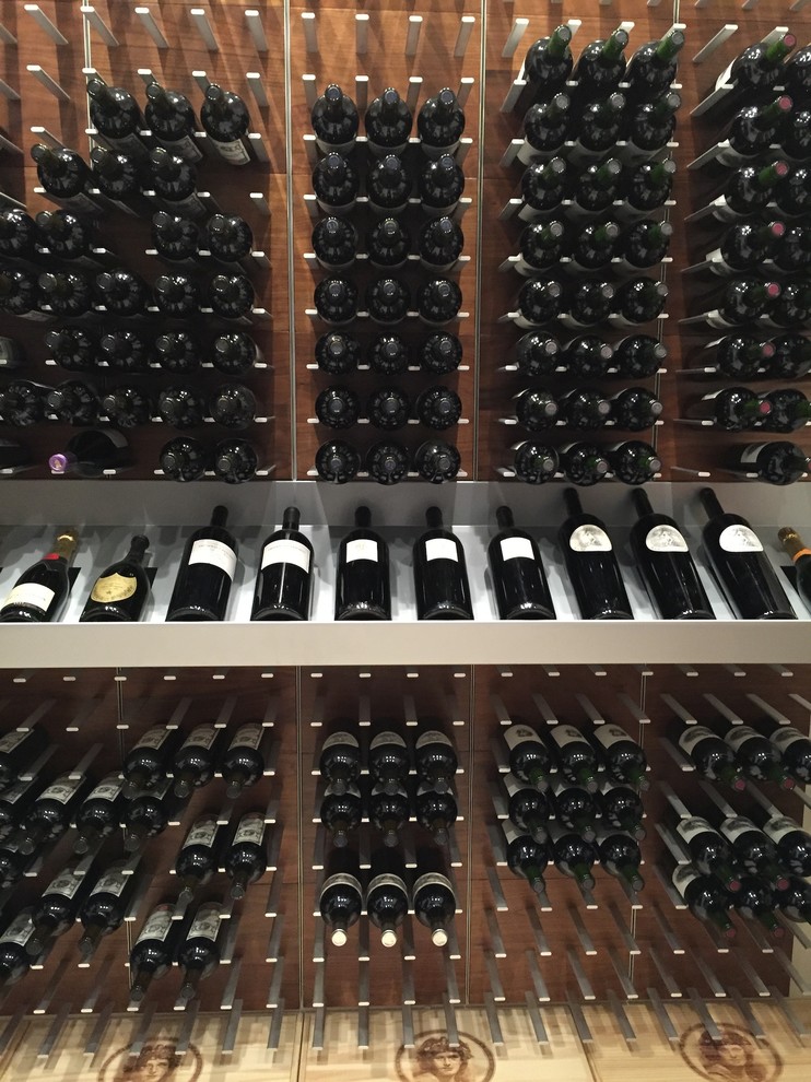 This is an example of a medium sized contemporary wine cellar in Copenhagen with cube storage.