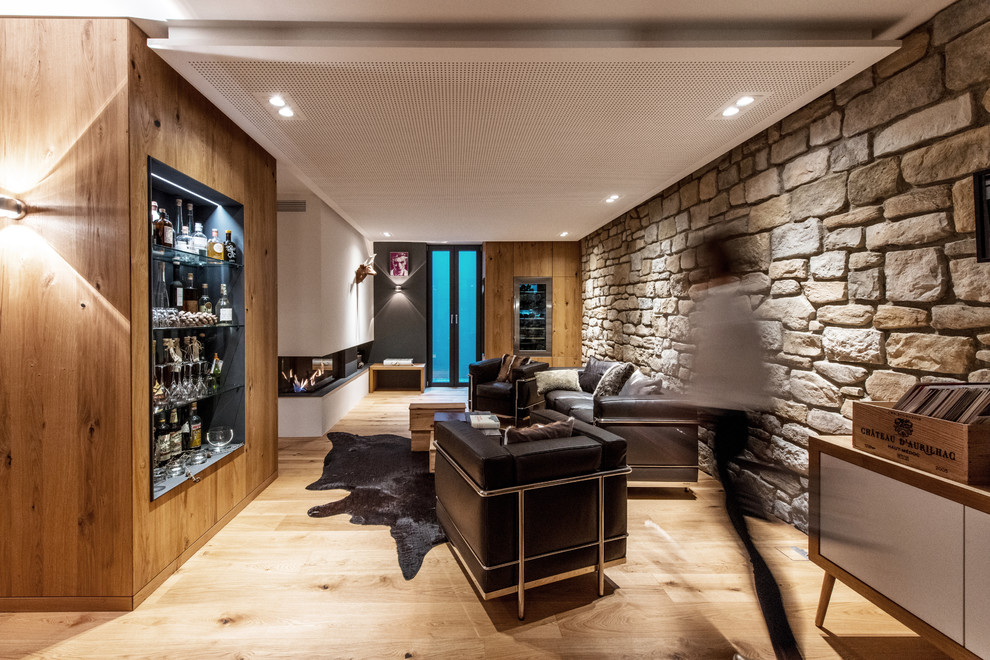 Example of a mid-sized urban medium tone wood floor and brown floor wine cellar design in Other with display racks