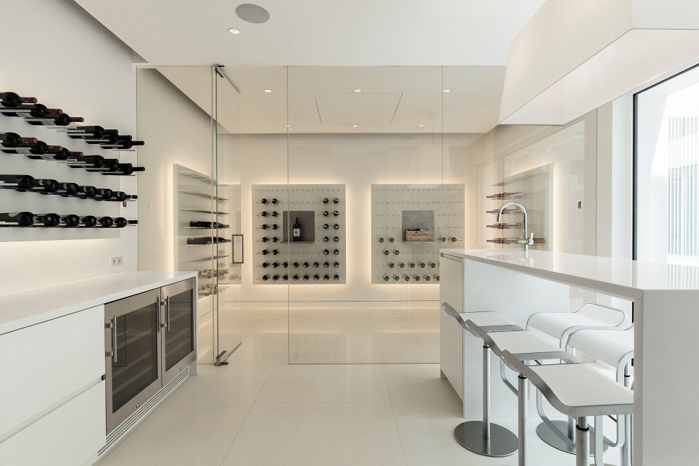 Large contemporary wine cellar in Palma de Mallorca with porcelain flooring, display racks and beige floors.