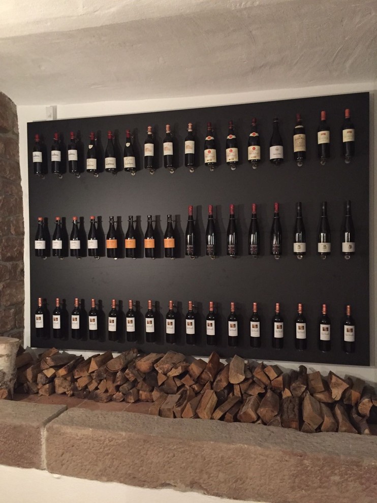 Example of a huge ceramic tile and gray floor wine cellar design in Other