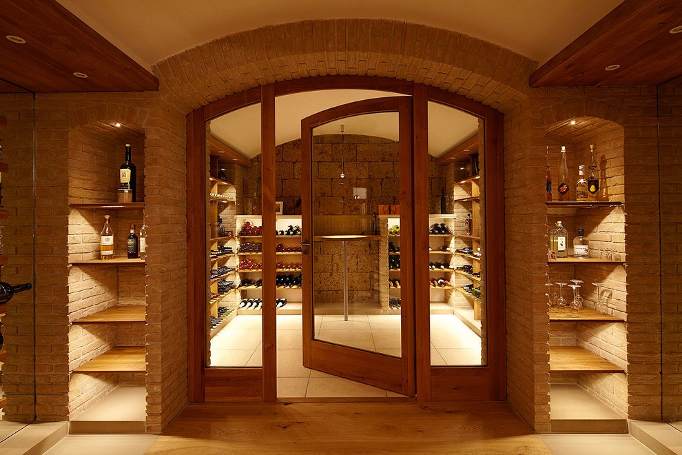 Large traditional wine cellar in Stuttgart with medium hardwood flooring and storage racks.