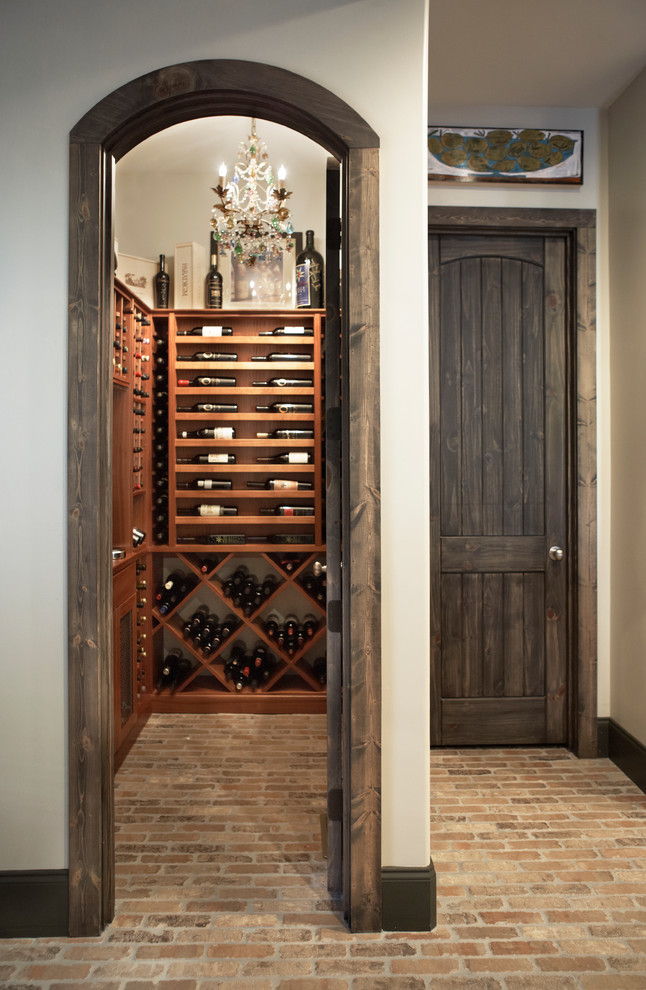 Inspiration for a timeless brick floor wine cellar remodel in Other with display racks