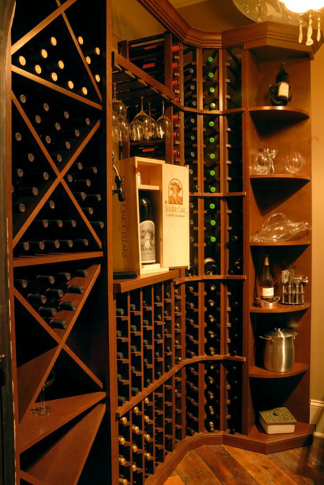 This is an example of a small mediterranean wine cellar in New Orleans with medium hardwood flooring and storage racks.