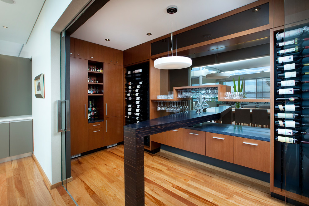 Wine cellar - large contemporary medium tone wood floor wine cellar idea in Other with display racks