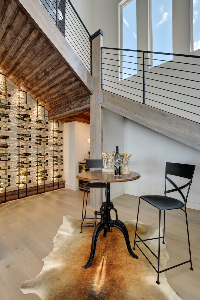 Design ideas for a medium sized urban wine cellar in Austin with light hardwood flooring and storage racks.