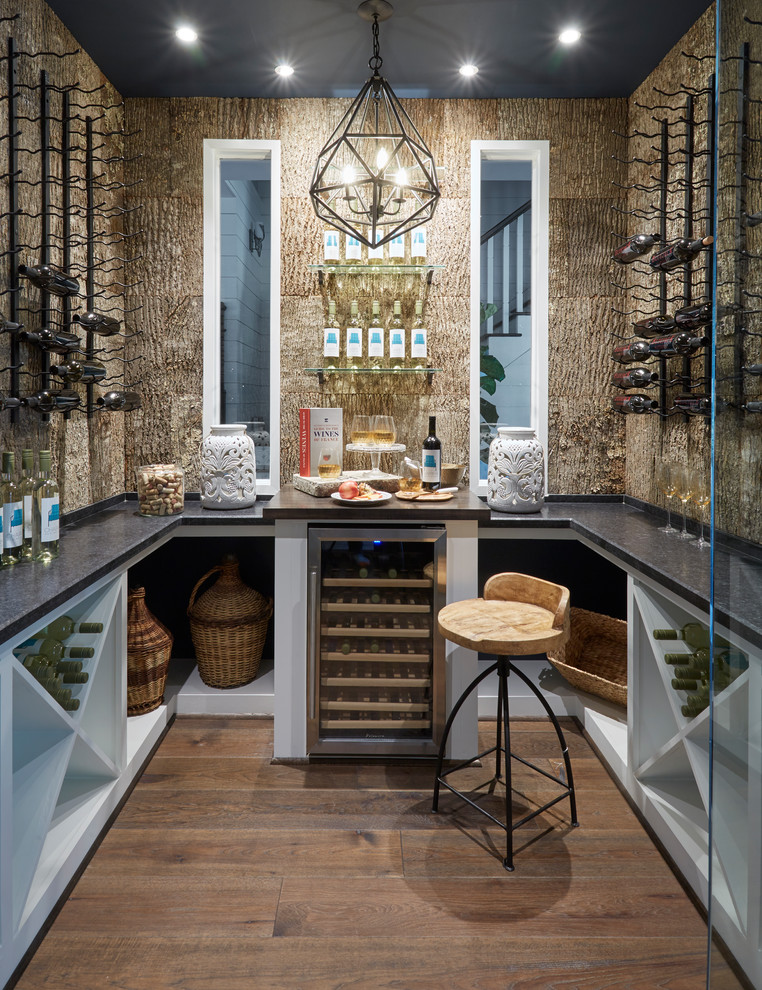 Wine cellar - mid-sized traditional dark wood floor and brown floor wine cellar idea in Houston with diamond bins