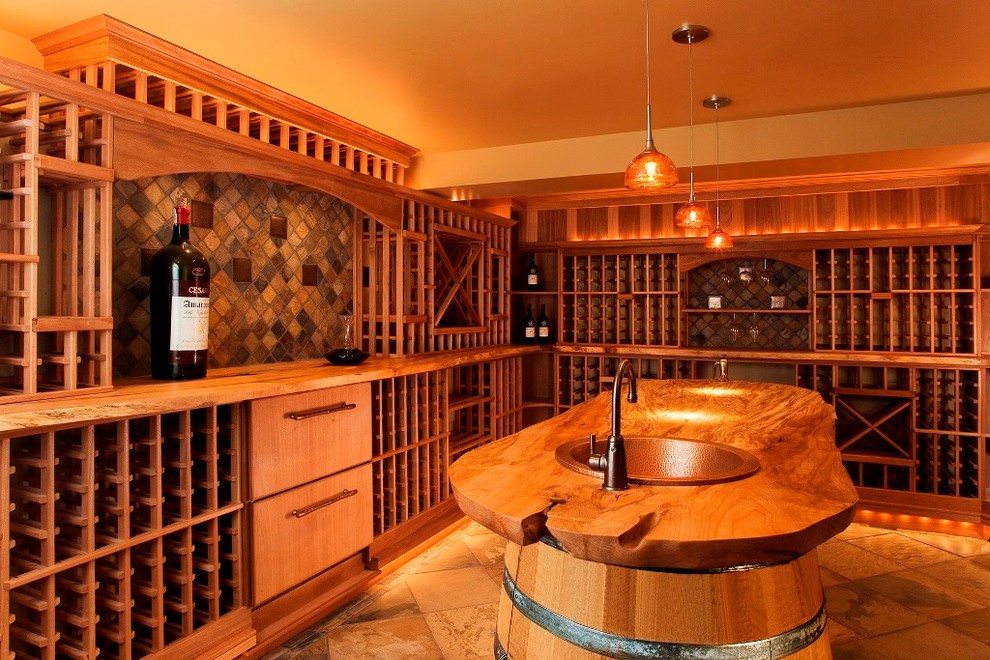 Wine cellar - large rustic slate floor wine cellar idea in Seattle with storage racks
