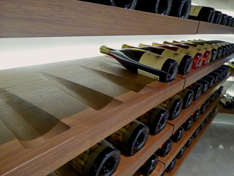 Design ideas for a small modern wine cellar in Portland with concrete flooring and display racks.
