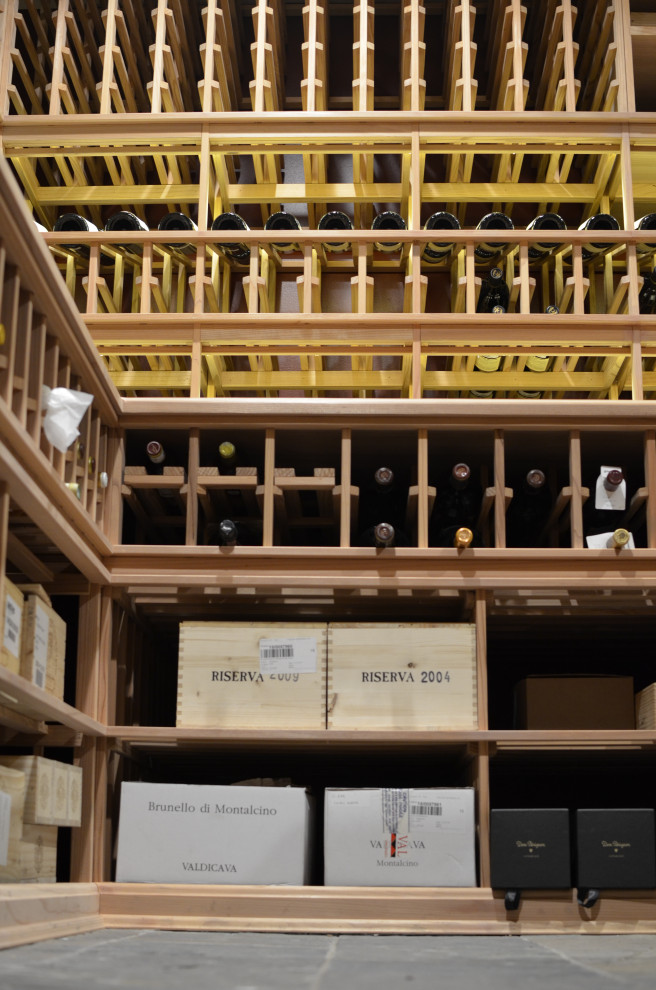 Photo of a large traditional wine cellar in New York with storage racks and grey floors.