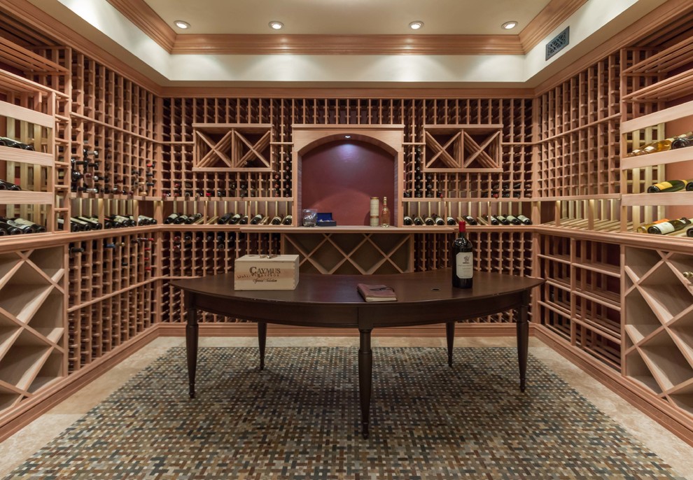 Example of a classic carpeted wine cellar design in Boston with diamond bins