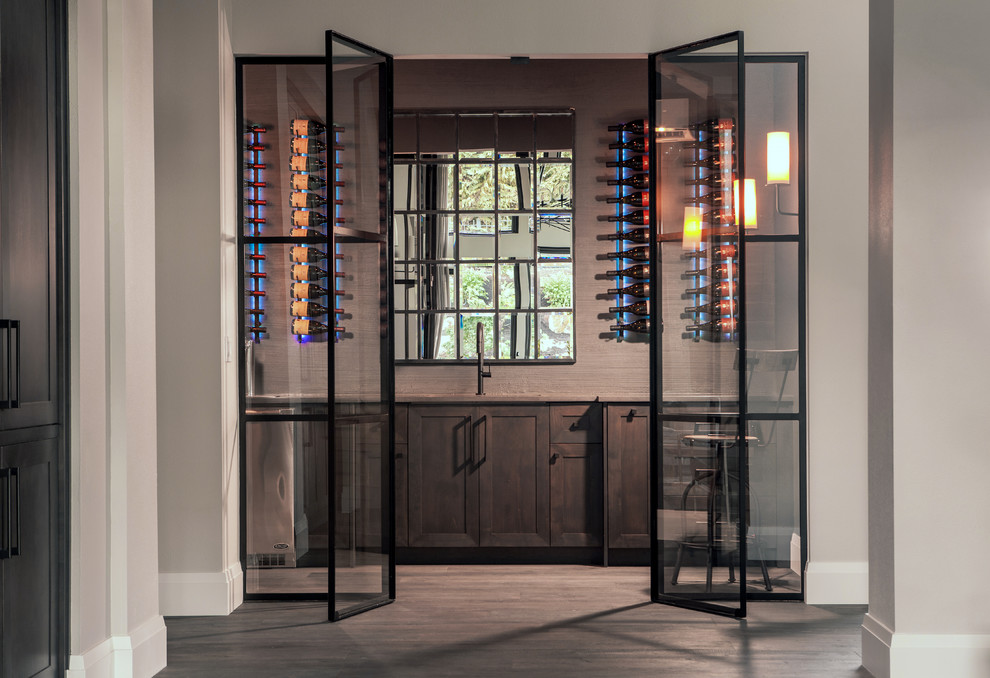 Photo of a small country wine cellar in Portland with dark hardwood flooring and storage racks.