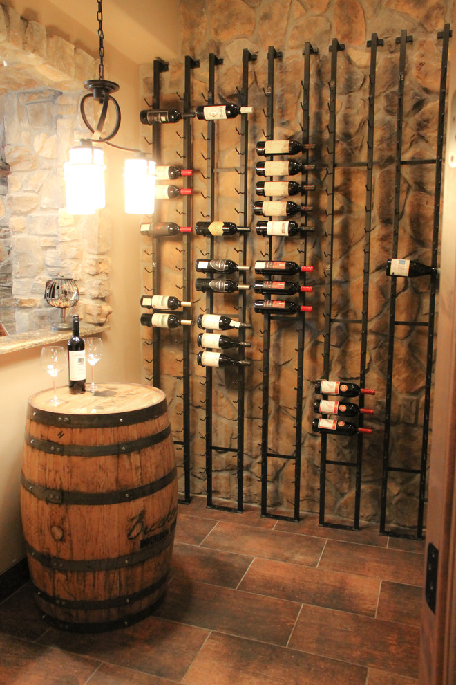 Small elegant terra-cotta tile wine cellar photo in Denver with display racks