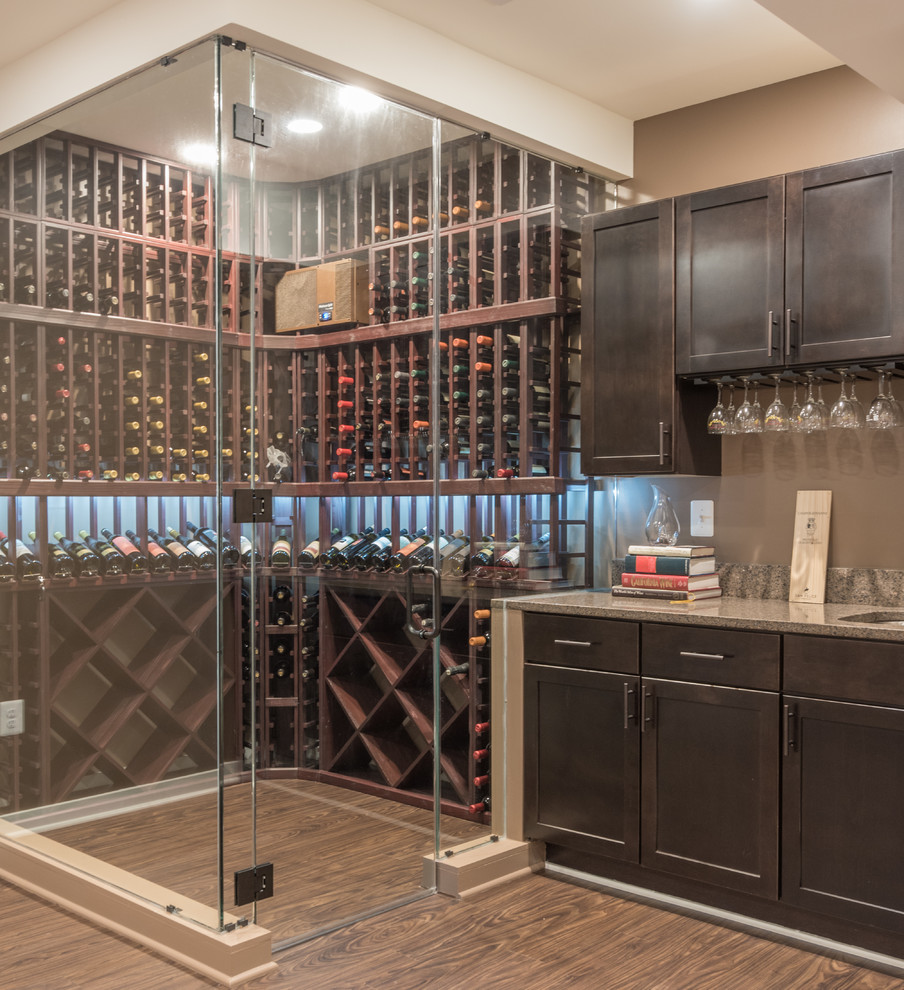 Large midcentury wine cellar in DC Metro with medium hardwood flooring and storage racks.