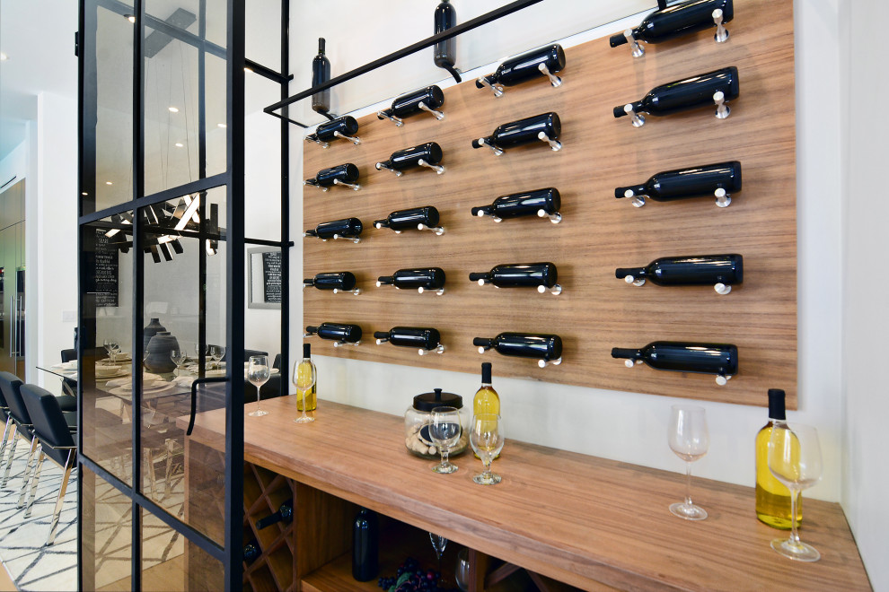 Wine cellar - small contemporary wine cellar idea in Los Angeles with diamond bins