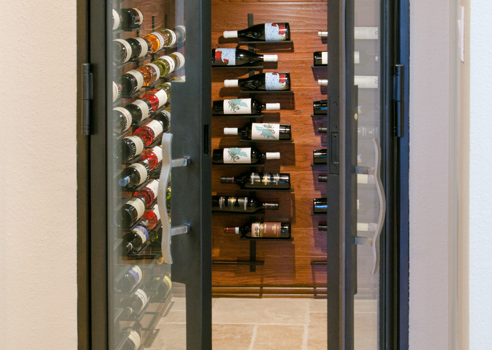 Wine cellar - mediterranean travertine floor wine cellar idea in Dallas with display racks