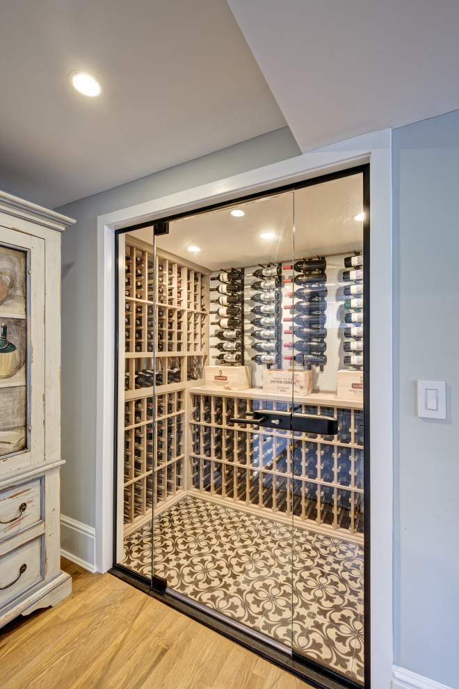 Inspiration for a medium sized beach style wine cellar in New York with concrete flooring, storage racks and multi-coloured floors.