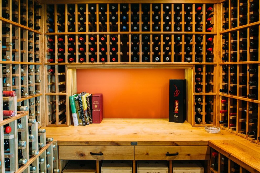Large eclectic light wood floor wine cellar photo in Los Angeles with storage racks