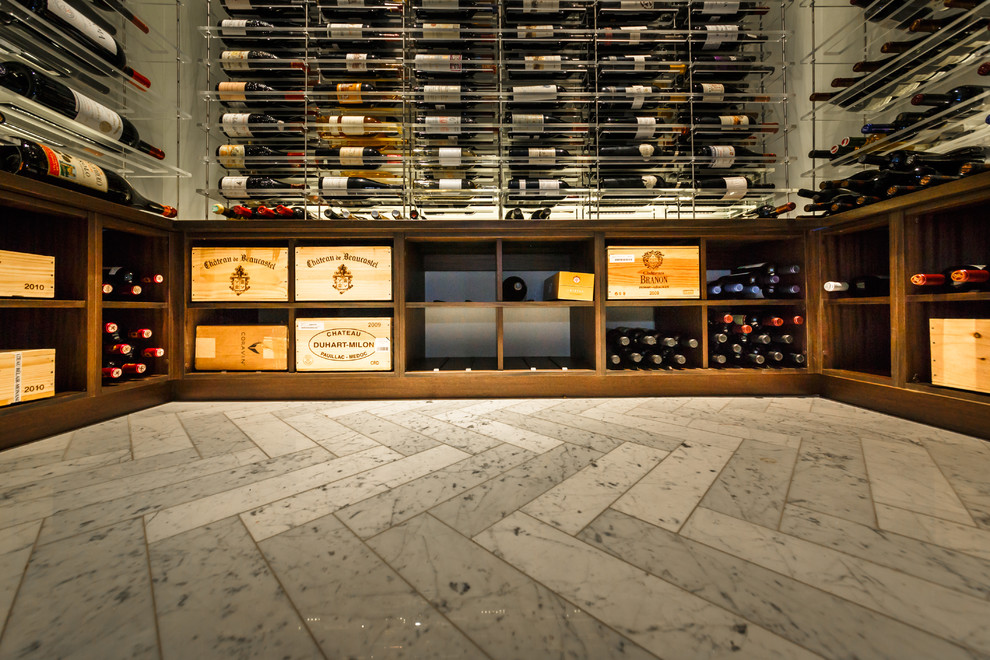 Photo of a medium sized modern wine cellar in New York with marble flooring, display racks and white floors.