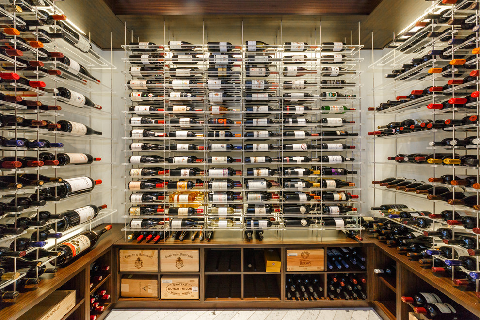 Wine cellar - mid-sized modern marble floor and white floor wine cellar idea in New York with display racks