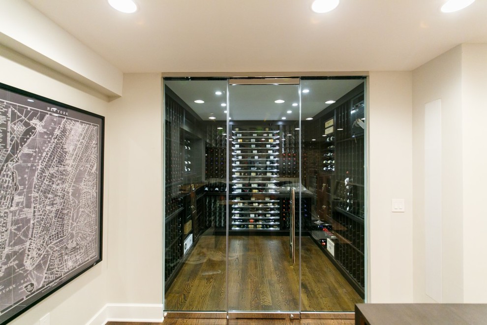 Mid-sized trendy medium tone wood floor wine cellar photo in New York with display racks