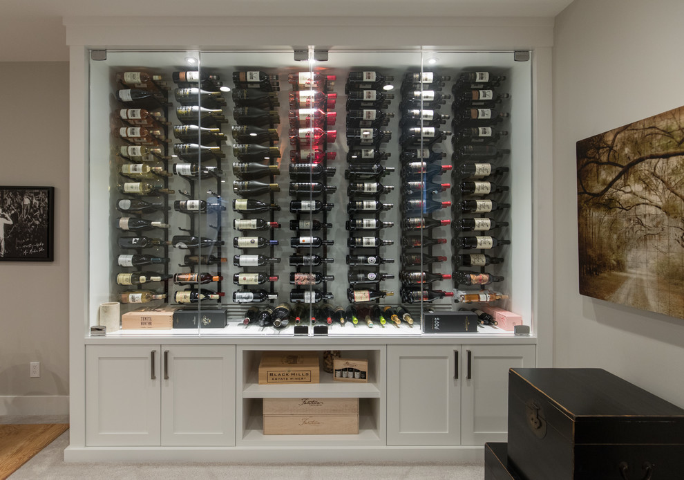 This is an example of a small contemporary wine cellar in Calgary with display racks.