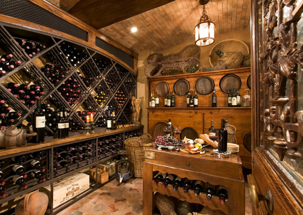 Medium sized mediterranean wine cellar in Orange County with cube storage.