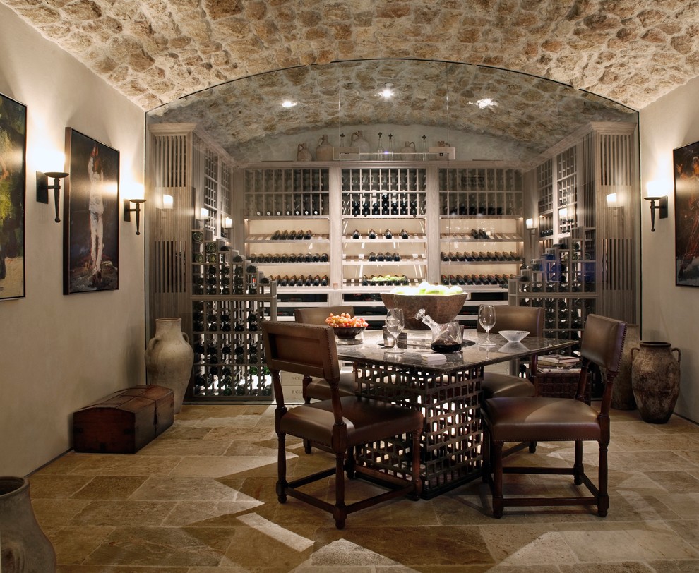 Example of a tuscan wine cellar design in Orange County with display racks