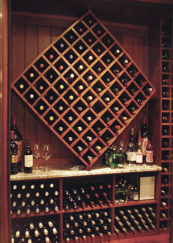 Inspiration for a small timeless dark wood floor wine cellar remodel in Milwaukee with display racks