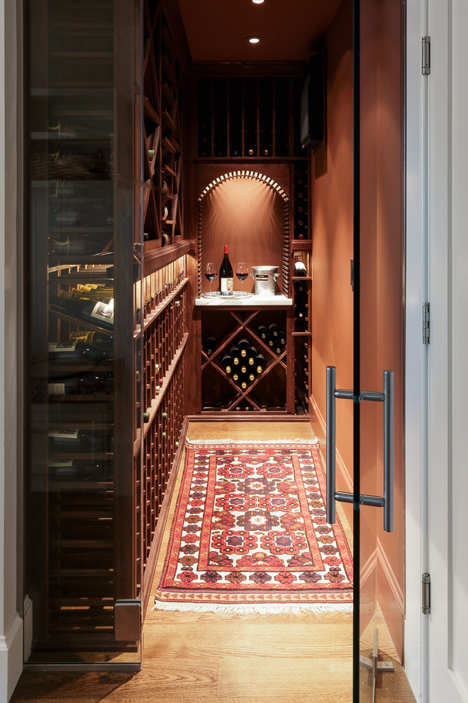Example of a small trendy medium tone wood floor wine cellar design in San Francisco with storage racks