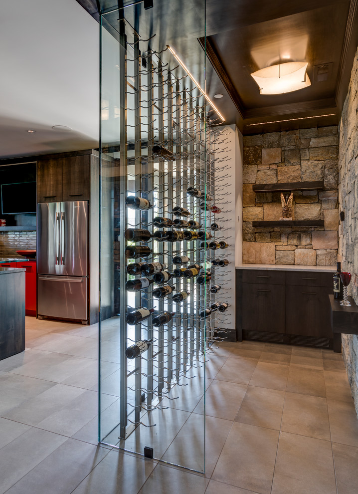 Example of a mountain style gray floor wine cellar design with storage racks