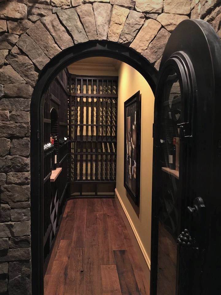 Inspiration for a small timeless medium tone wood floor and brown floor wine cellar remodel in Atlanta