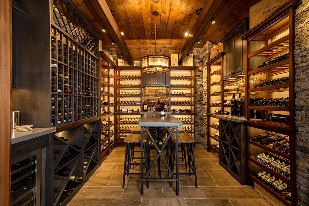 Example of a mid-sized transitional ceramic tile and gray floor wine cellar design in New York with display racks