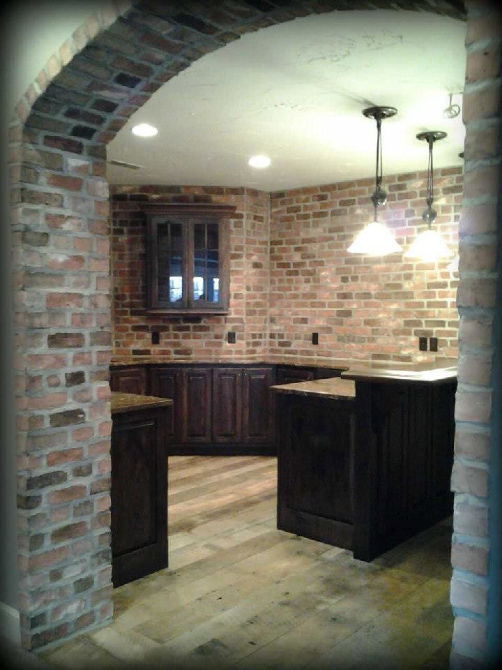This is an example of a medium sized rustic home bar in Cleveland with dark hardwood flooring.