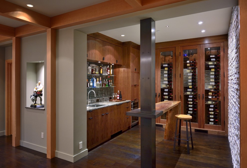 Photo of a rustic wine cellar in Seattle with display racks, dark hardwood flooring and brown floors.