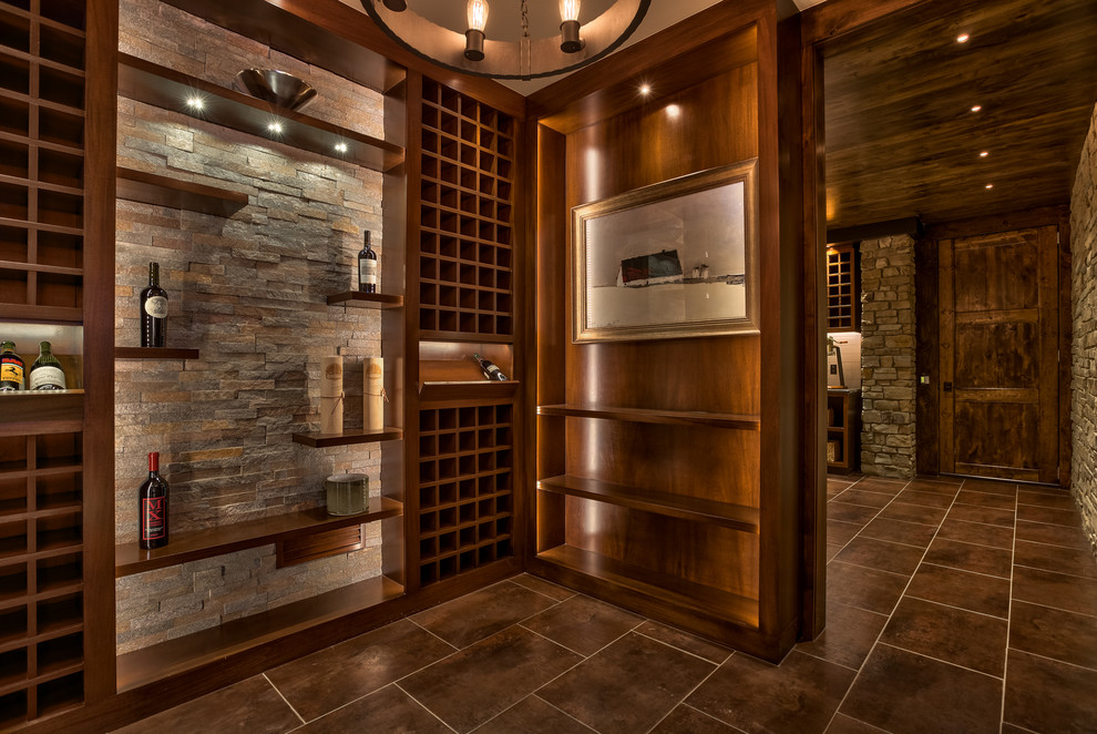 This is an example of a large contemporary wine cellar in Omaha with ceramic flooring and display racks.