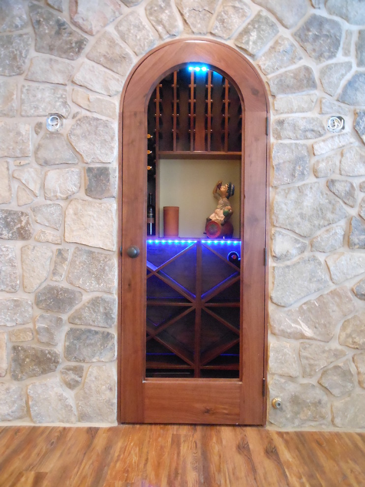 This is an example of a medium sized classic wine cellar in Philadelphia with medium hardwood flooring, cube storage and brown floors.