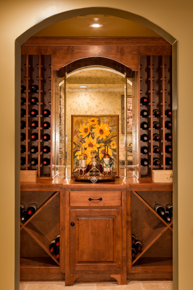 This is an example of a small traditional wine cellar in Atlanta with travertine flooring and cube storage.