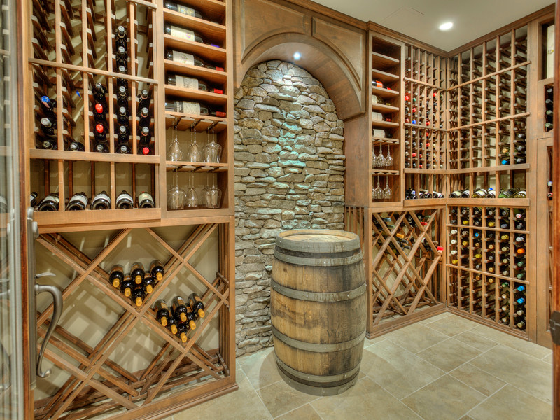 Large traditional wine cellar in New York with ceramic flooring and storage racks.