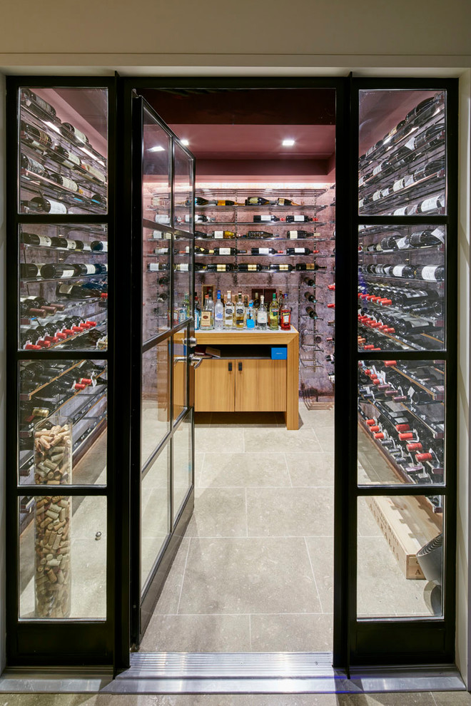Design ideas for a small contemporary wine cellar in New York with storage racks, beige floors and limestone flooring.