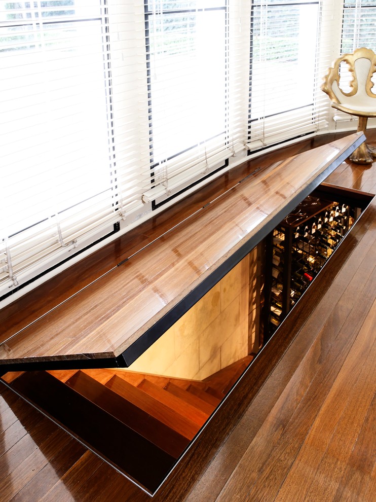 Inspiration for a mid-sized modern wine cellar remodel in Sydney with storage racks