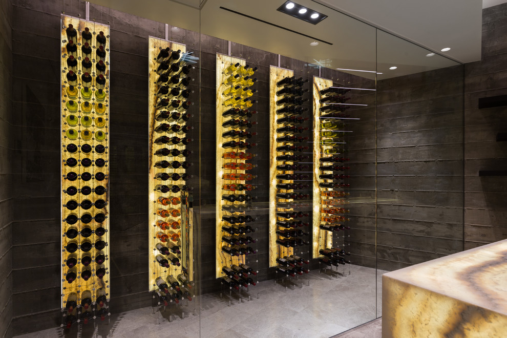 Photo of a contemporary wine cellar in Orange County with storage racks and grey floors.