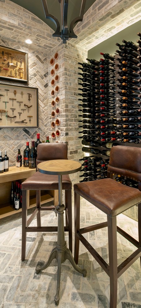 Inspiration for a medium sized traditional wine cellar in Houston with brick flooring, display racks and grey floors.