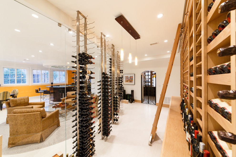 Example of a huge minimalist marble floor and white floor wine cellar design in New York with storage racks