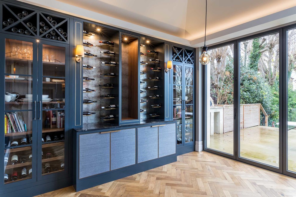 Inspiration for a large modern wine cellar in Other with medium hardwood flooring, storage racks and brown floors.