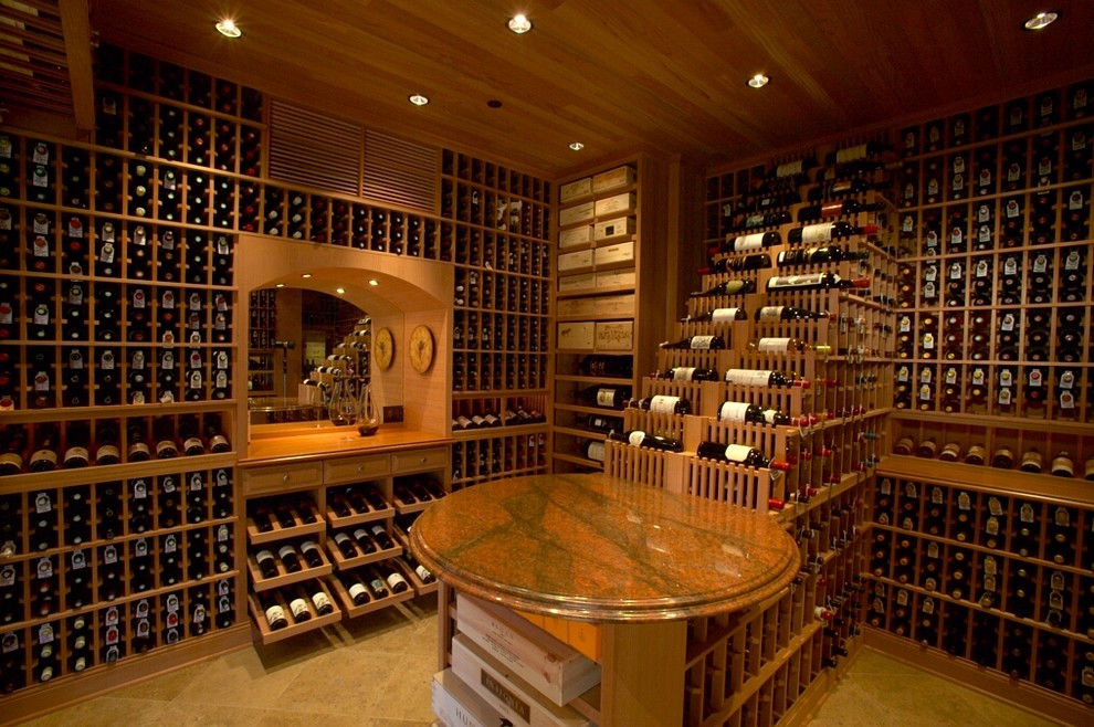 Wine cellar - large traditional terra-cotta tile wine cellar idea in Los Angeles with display racks