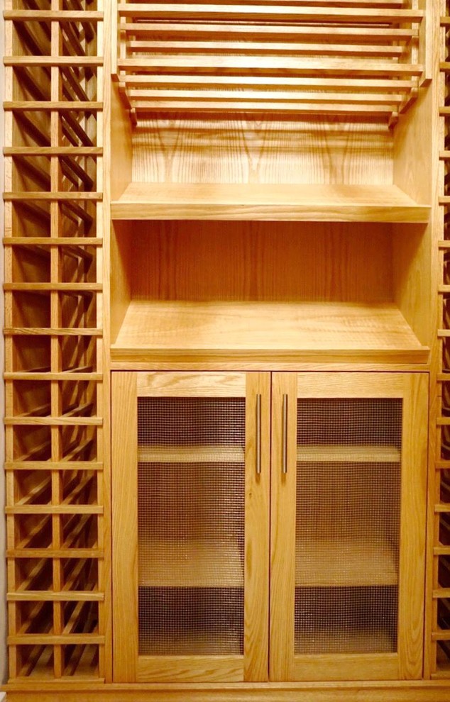 Wine cellar - mid-sized traditional marble floor wine cellar idea in Vancouver with storage racks