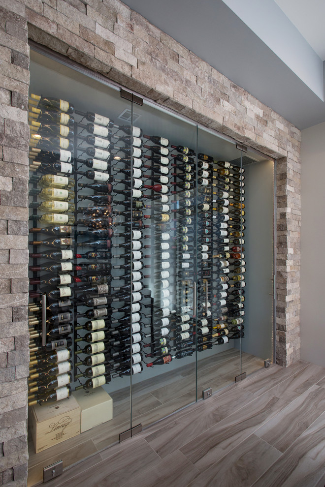 Example of a small trendy medium tone wood floor wine cellar design in Los Angeles with display racks