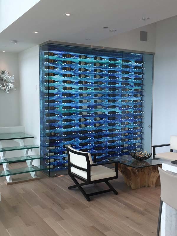 Inspiration for a small modern wine cellar in Miami with light hardwood flooring, display racks and beige floors.